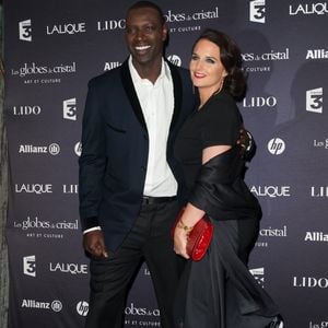 Omar Sy et son épouse assistent à la 7ème cérémonie des Globes de Cristal qui se tient au Lido sur les Champs Elysées à Paris, France, le 6 février 2012. Photo ABACAPRESS.COM
