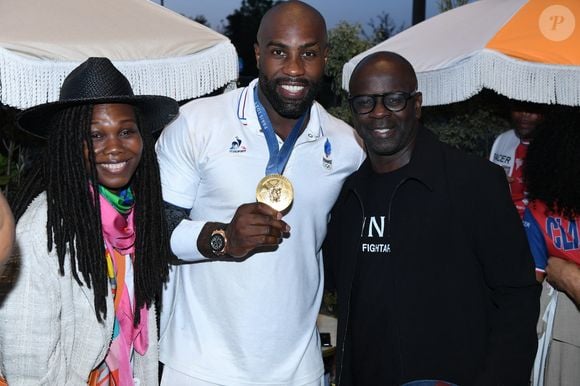 Exclusif - Lilian Thuram avec sa femme Kareen Guiock Thuram, Teddy Riner - Teddy Riner fête son titre de champion Olympique de judo +100KG au restaurant "Podium" du groupe (Les bistrots Pas Parisiens) à Paris le 2 aout 2024. © Rachid Bellak/Bestimage