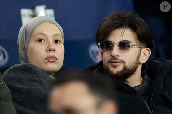 Just Riadh et sa femme dans les tribunes lors du match de Ligue Des Champions 2024-2025 (LDC) "PSG - Brest (7-0)" au Parc Des Princes, le 19 février 2025.
© Cyril Moreau/Bestimage