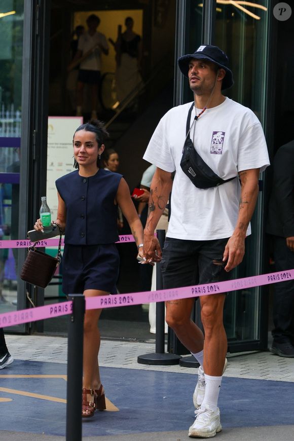 Paris, FRANCE  - Florent Manaudou and Lola Dumenil hand in hand at the France Germany basketball semi-final Olympic Games Paris 2024 in Paris, France.



Pictured: Florent Manaudou, Lola Dumenil