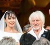 Hugues Aufray a partagé sur son compte Instagram un des clichés du mariage de son épouse et lui durant la soirée, avec leur chat Lily Flower dans les bras de la mariée.

Murielle Mégevand et Hugues Aufray sur le parvis de l'église - Mariage d'Hugues Aufray et de Murielle Mégevand à l’église Saint-Vigor de Marly-Le Roy, France, le 2 septembre 2023. 

Photo : Agence / Bestimage