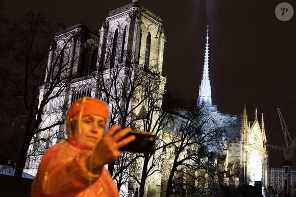 Vue de la flèche de Notre-Dame de Paris et de son ombre illuminée lors d'une cérémonie marquant la réouverture de la cathédrale, dans le centre de Paris, le 7 décembre 2024. Photo par Raphael Lafargue/ABACAPRESS.COM