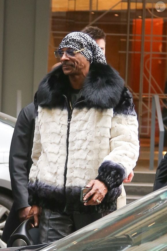 New York, NY  - EXCLUSIVE  - Snoop Dogg exudes style after joining Al Roker’s weather forecast live on TODAY in NYC, rocking a luxurious white and black fur coat, sleek black leather pants, and matching sneakers, while casually carrying a JBL speaker.



Pictured: Snoop Dogg