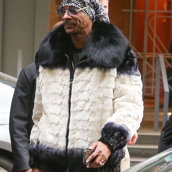 New York, NY  - EXCLUSIVE  - Snoop Dogg exudes style after joining Al Roker’s weather forecast live on TODAY in NYC, rocking a luxurious white and black fur coat, sleek black leather pants, and matching sneakers, while casually carrying a JBL speaker.



Pictured: Snoop Dogg