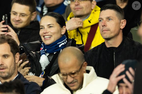 Rappelons qu'Andre est le père de son fils Cyan, né le 29 août 2022, mais le mannequin international est également la maman comblée de Valentina et Sienna, nées de son union passée avec le basketteur serbe Marko Jarić.

Adriana Lima et son compagnon Andre Lemmers - Célébrités dans les tribunes du match de 8ème de finale aller de la Ligue Des Champions 2025-2026 (LDC) "PSG - Chelsea (5-2)" au Parc des Princes à Paris le 11 mars 2026. © Cyril Moreau/Bestimage