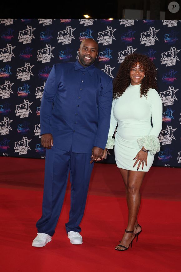 Teddy Riner et sa compagne Luthna Plocus au photocall de la 27ème édition des NRJ Music Awards au palais des Festivals de Cannes, France, le 31 octobre 2025. © Dominique Jacovides/Bestimage