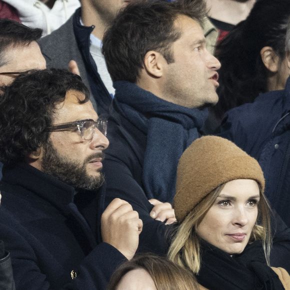 Maxim Nucci (Yodelice) et sa compagne Isabelle Ithurburu dans les tribunes lors du match de rugby du Tournoi des 6 Nations opposant la France à l'Angleterre au stade de France, à Saint-Denis, Seine Saint-Denis, France, le 19 mars 2022. © Cyril Moreau/Bestimage