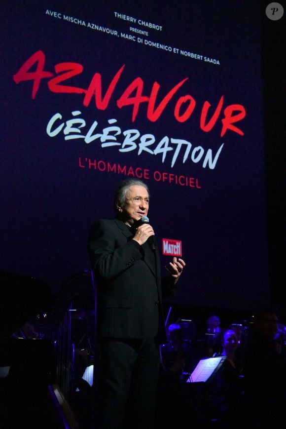 Exclusif - Michel Drucker - Spectacle symphonique "Aznavour Célébration - l'hommage officiel" en clôture du centenaire de la naissance de C. Aznavour au palais des Congrès à Paris le 23 novembre 2024. "Aznavour Célébration - Le Spectacle Symphonique," présenté par Michel Drucker, un événement exceptionnel, sous la direction artistique de Mischa Aznavour, qui rend hommage à l'une des plus grandes voix de la chanson française, Charles Aznavour. Ce concert unique en son genre réuni des artistes de renom et un orchestre symphonique composé de 80 musiciens pour célébrer tout en musiques et en images, l'héritage incomparable de cet artiste légendaire. Cet événement, voulu par la famille Aznavour comme l’hommage officiel dans le cadre des célébrations du centenaire, s'est tenu le samedi 23 novembre 2024 au Palais des Congrès de Paris. Un lieu emblématique qui a souvent accueilli Aznavour tout au long de sa carrière et qui fut sa salle « fétiche ». Ce show proposera des interprétations magistrales des plus grands succès de Charles Aznavour, réarrangés en symphonique sous la direction du chef d'orchestre Vahan Mardirossian, pour accompagner la voix du « Grand Charles ». Les spectateurs auront le privilège d'entendre des titres emblématiques tels que "La Bohème," "Emmenez-moi," et "Hier encore" et tant d’autres dans des versions symphoniques inédites, offrant une nouvelle dimension à ces chefs-d'œuvre. Des artistes invités, comme notamment Alain Chamfort, Thomas Dutronc, Antoine Delie, Noha. R et bien d’autres, se joindront à l'orchestre pour interpréter ces chansons qui ont marqué des générations. Deux heures de spectacle avec une entracte de 15mn. "Aznavour Célébration" proposé par Thierry Chabrot, n'est pas seulement un concert, mais aussi un ciné-concert pour mettre en avant un autre de ses talents, celui d’acteur. Une véritable immersion dans l'univers d'un artiste dont les paroles, la musique et rôles au cinéma continuent de toucher les cœurs à travers le monde. Cet événement est également une opportunité de rappeler l'impact culturel et émotionnel de Charles Aznavour, et de célébrer la longévité de son œuvre. © Lydia Kasparian/ Bestimage 
No Web - Belgique et Suisse