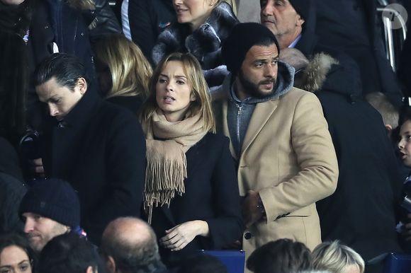 Maxim Nucci et sa compagne Isabelle Ithurburu enceinte assistent au huitième de finale retour de Ligue des Champion, du Paris Saint-Germain contre le Real Madrid au Parc des Princes à Paris le 6 mars 2018. © Cyril Moreau/Bestimage