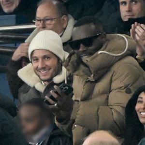 Louis Garrel, Vianney, Gims et sa femme DemDem, Jérôme Rothen - Célébrités dans les tribunes du match de Ligue 1 McDonald's opposant le Paris Saint-Germain (PSG) à Lyon (3-1) au Parc des Princes à Paris le 15 décembre 2024.