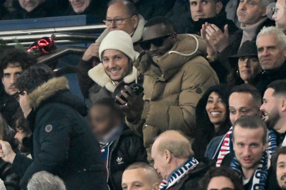 Louis Garrel, Vianney, Gims et sa femme DemDem, Jérôme Rothen - Célébrités dans les tribunes du match de Ligue 1 McDonald's opposant le Paris Saint-Germain (PSG) à Lyon (3-1) au Parc des Princes à Paris le 15 décembre 2024.