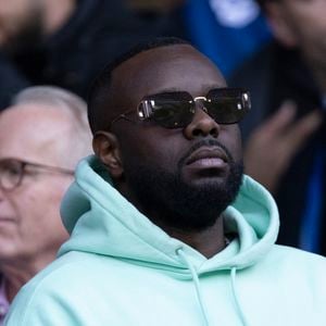 Gims dans les tribunes lors du match retour de la Ligue Des Champions 2024-2025 (LDC) "PSG - Arsenal" (2-1) au Parc des Princes à Paris le 7 mai 2025.

© Cyril Moreau/Bestimage