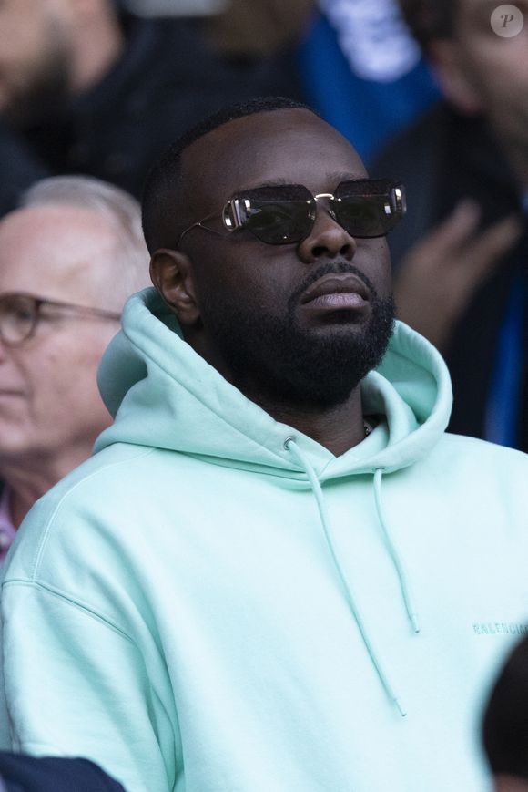 Gims dans les tribunes lors du match retour de la Ligue Des Champions 2024-2025 (LDC) "PSG - Arsenal" (2-1) au Parc des Princes à Paris le 7 mai 2025.

© Cyril Moreau/Bestimage