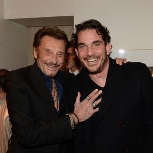 Johnny Hallyday et Sébastien Farran lors d'un événement chez Montaigne Market à Paris le 4 mars 2016. Photo par Bestimage
