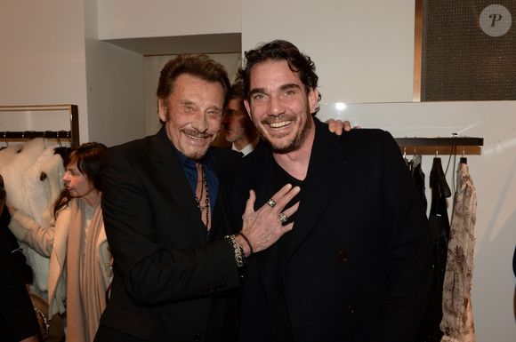 Johnny Hallyday et Sébastien Farran lors d'un événement chez Montaigne Market à Paris le 4 mars 2016. Photo par Bestimage