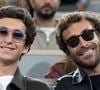 Il s'est livré sur ce besoin viscéral d'évasion et de rencontres.

Raphaël Kretz et Martin Kretz dans les tribunes lors des Internationaux de France de Tennis de Roland Garros 2025, à Paris, France, le 5 juin 2025. 

© Jacovides-Moreau/Bestimage