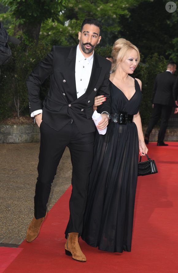 Adil Rami et sa compagne Pamela Anderson arrivent à la 28ème cérémonie des trophées UNFP (Union nationale des footballeurs professionnels) au Pavillon d'Armenonville à Paris, France, le 19 mai 2019. © Coadic Guirec/Bestimage
