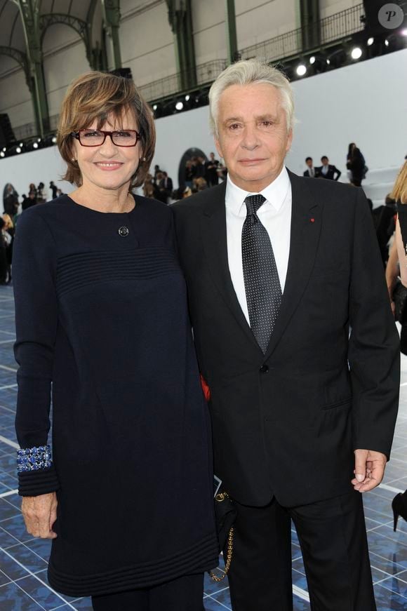 Michel Sardou et son épouse Anne-Marie Perier assistent au défilé de la collection prêt-à-porter printemps-été 2013 de Chanel qui s'est tenu au Grand Palais à Paris, France, le 2 octobre 2012. Photo by Thierry Orban/ABACAPRESS.COM