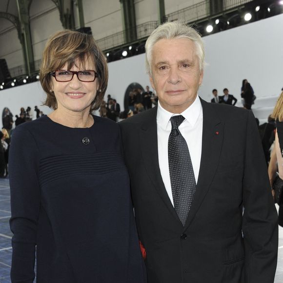 Michel Sardou et son épouse Anne-Marie Perier assistent au défilé de la collection prêt-à-porter printemps-été 2013 de Chanel qui s'est tenu au Grand Palais à Paris, France, le 2 octobre 2012. Photo by Thierry Orban/ABACAPRESS.COM