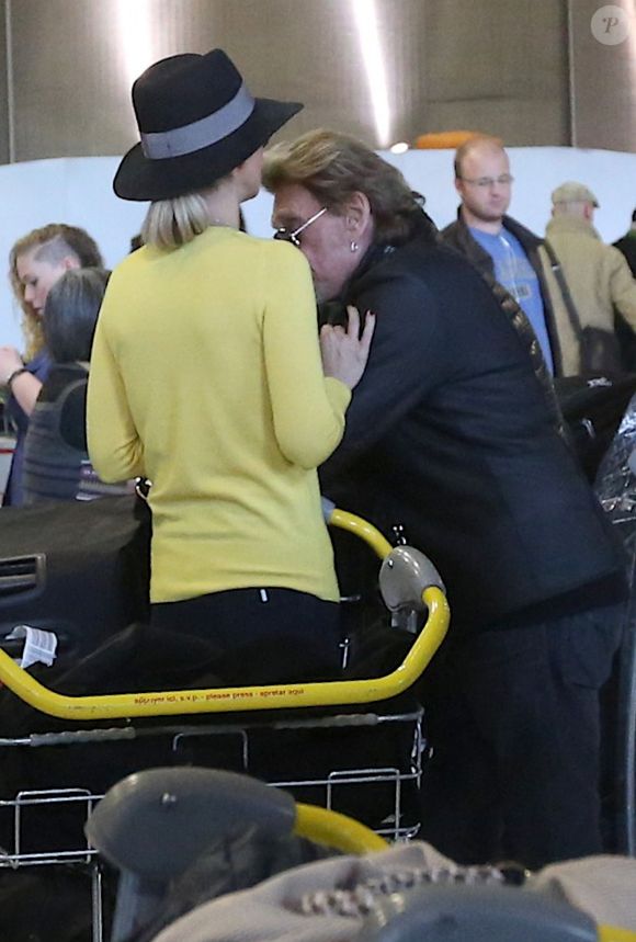 Johnny et Laeticia Hallyday - Johnny Hallyday est arrivé ce matin a Paris en provenance de Los Angeles avec sa femme Laeticia, ses filles Jade et Joy, Elyette (la grand-mere de laeticia), son chien Santos, la nounou, ses musiciens dont son guitariste Robin Le Mesurier et ses choristes le 8 decembre 2013. © Agence / BESTIMAGE