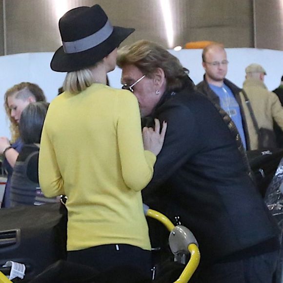 Johnny et Laeticia Hallyday - Johnny Hallyday est arrivé ce matin a Paris en provenance de Los Angeles avec sa femme Laeticia, ses filles Jade et Joy, Elyette (la grand-mere de laeticia), son chien Santos, la nounou, ses musiciens dont son guitariste Robin Le Mesurier et ses choristes le 8 decembre 2013. © Agence / BESTIMAGE