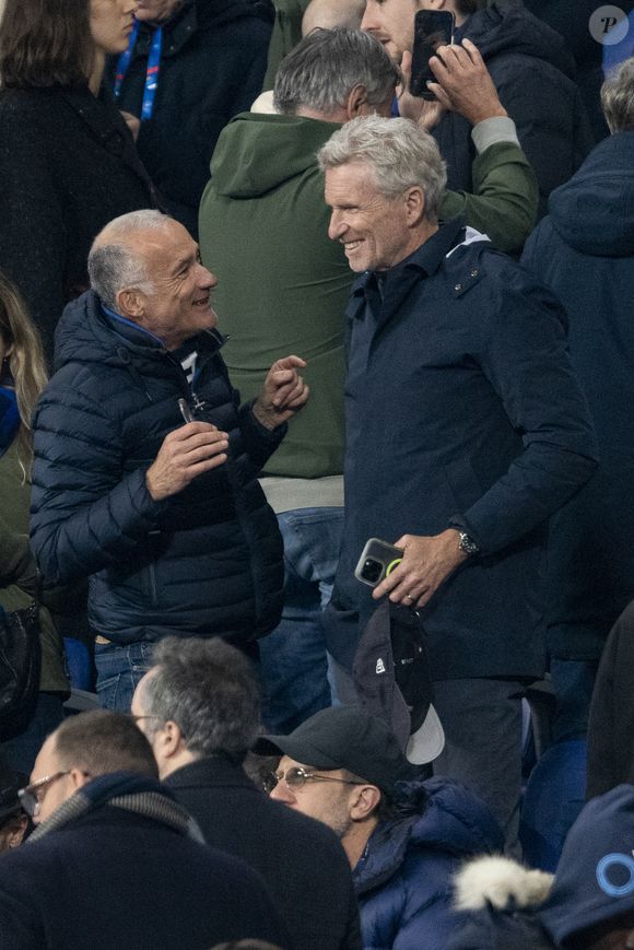 Gilles Bouleau et Denis Brogniart - Célébrités dans les tribunes du quart de finale de la Ligue des Nations de l'UEFA 2025 "France - Croatie (2-0 / tab 5-4)" au Stade de France à Saint-Denis le 23 mars 2025. © Cyril Moreau/Bestimage