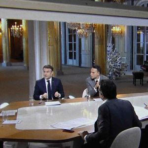 Le président français Emmanuel Macron avec Anne-Elisabeth Lemoine, Mohamed Bouhafsi, Patrick Cohen sur un écran de télévision à Paris lors d'une interview en direct diffusée dans l'émission '' C a vous '' de France 5, le 20 décembre 2023. Photo by Eliot Blondet/ABACAPRESS.COM