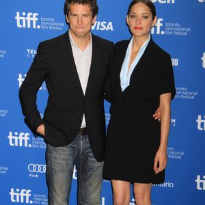 Guillaume Canet et Marion Cotillard (habillee en Dior Haute Couture) - Photocall du film "Blood Ties" au festival du Film de Toronto le 10 septembre 2013 FAMEFLYNET / BESTIMAGE