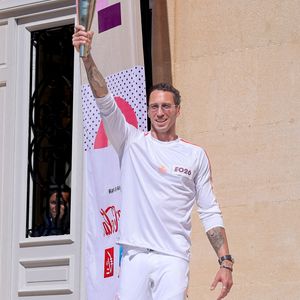 Frédérick Bousquet avec la flamme lors de la première étape du relais de la flamme olympique à Marseille, France, le 9 mai 2024.  © Dominique Jacovides/Bestimage