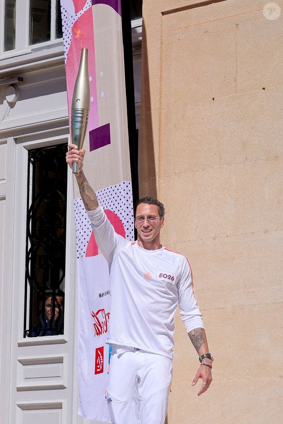 Frédérick Bousquet avec la flamme lors de la première étape du relais de la flamme olympique à Marseille, France, le 9 mai 2024.  © Dominique Jacovides/Bestimage