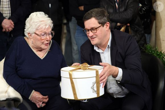 Arnaud Deslandes, maire de Lille, offre à Line Renaud un gateau venant de la patisserie Meert - Line Renaud, 97 ans, a inauguré un jardin public qui porte son nom, à Lille, France, le mercredi 17 décembre 2025.

© Claude Dubourg/Bestimage