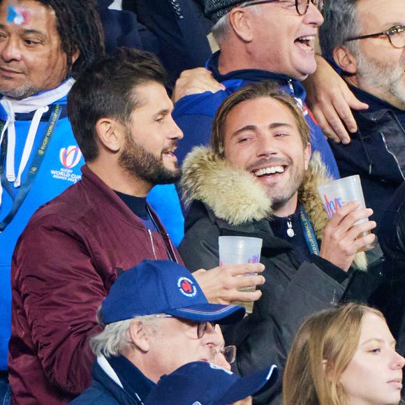 Christophe Beaugrand et son mari Ghislain Gerin dans les tribunes de la coupe du Monde de Rugby France 2023 - Match de quart de finale "France-Afrique du Sud (28-29)" au Stade de France à Saint-Denis 15 octobre 2023. © Moreau-Jacovides/Bestimage